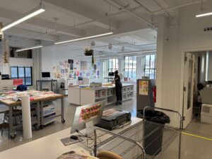 A wide view of a large room filled with desks and workspaces